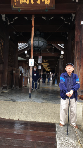 A Japanese elder in front of a temple